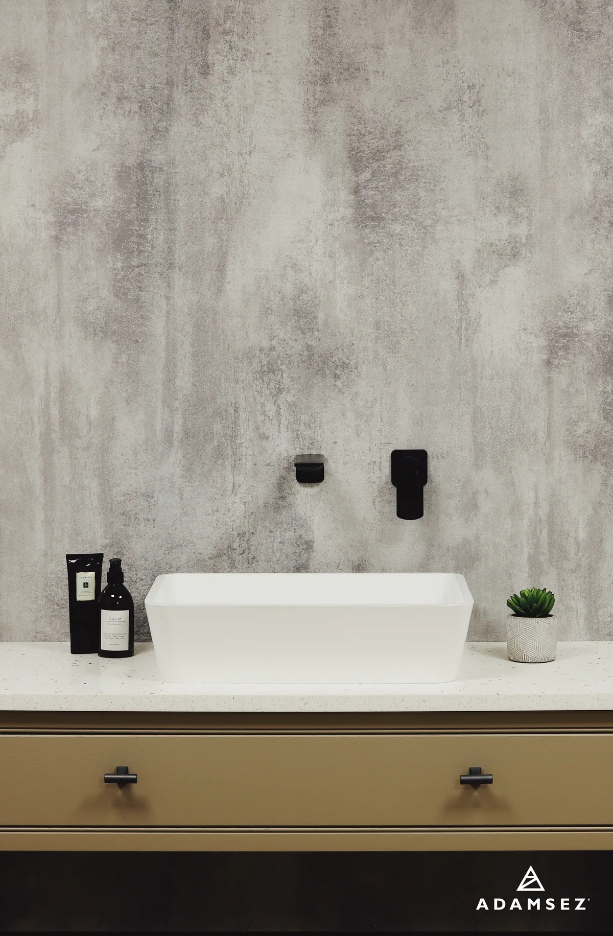 Adamsez Piazza basin with a bronze finish and dark wall-mounted tap